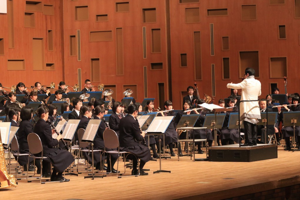 写真、市立尼崎高等学校吹奏楽部に指導する様子